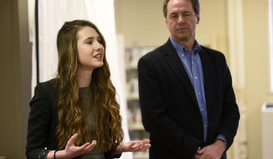 ADVANCE FOR WEEKEND EDITIONS - In this Tuesday, April 12, 2016 photo, Flathead junior Sophia Skwarchuk speaks about MontanaEats, an app she coded, as Montana Gov. Steve Bullock listens at the ImagineIF Library in Kalispell, Mont. (Aaric Bryan/The Daily Inter Lake via AP) MANDATORY CREDIT
