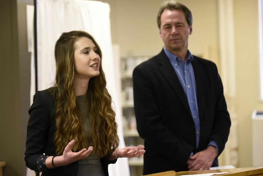 ADVANCE FOR WEEKEND EDITIONS - In this Tuesday, April 12, 2016 photo, Flathead junior Sophia Skwarchuk speaks about MontanaEats, an app she coded, as Montana Gov. Steve Bullock listens at the ImagineIF Library in Kalispell, Mont. (Aaric Bryan/The Daily Inter Lake via AP) MANDATORY CREDIT