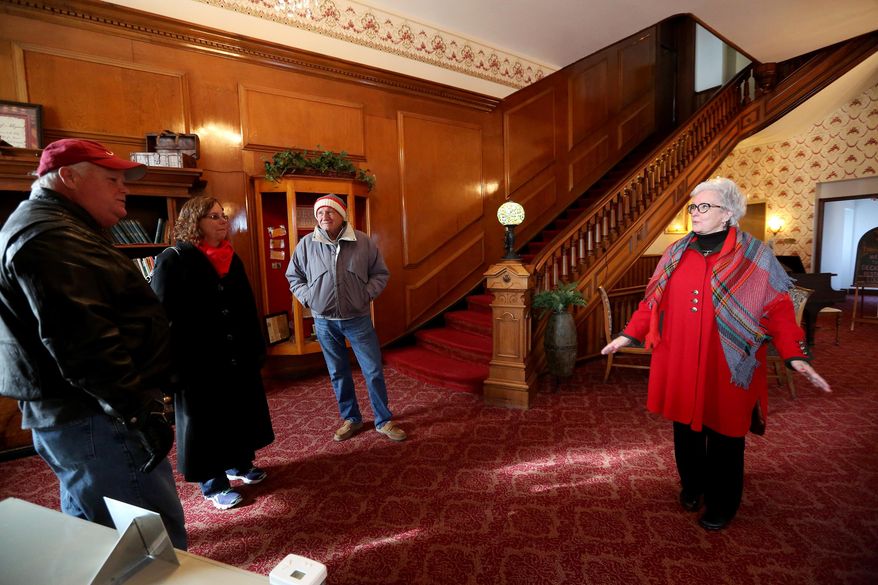 ADVANCE FOR SUNDAY APRIL 24 - In this April 7, 2016 photo, hotel guest Mary Mcareavy Lewis, right, of Melbourne, Fla., discusses memories at Decker Hotel in Maquoketa, Iowa. Maquoketa Betterment Corp. purchased the hotel at the end of 2015 as part of multi-year effort to save the historic landmark and update it with modern amenities. Since then, the nonprofit community development group has restored and rejuvenated the hotel's 17 guest rooms and specialty suites, as well a restaurant and neighborhood pub.(Jessica Reilly/Telegraph Herald via AP) MANDATORY CREDIT