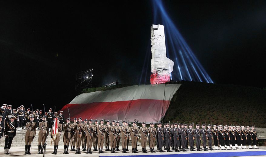 FILE - The May 8, 2015 file photo shows Polish Navy troops standing at the foot of the monument to Polish defenders of the Westerplatte peninsula, where some of World War II's first shots were fired, during ceremonies marking the 70th anniversary of the end of the war in Gdansk, Poland. A museum under creation for the past eight years, the Museum of the Second World War, was due to open in Gdansk in 2017 but its fate is threatened by the country's new nationalistic government. The government objects to its international approach and prefers a project that would focus exclusively on Westerplatte and the Polish military defense against Germany in 1939. (AP Photo/Czarek Sokolowski, file)