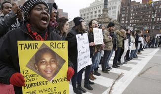 FILE - In this Nov. 25, 2014, file photo, demonstrators block Public Square in Cleveland, during a protest over the police shooting of Tamir Rice. The city of Cleveland has reached a settlement Monday, April 25, 2016, in a lawsuit over the death of Rice, a black boy shot by a white police officer while playing with a pellet gun. (AP Photo/Tony Dejak, File)