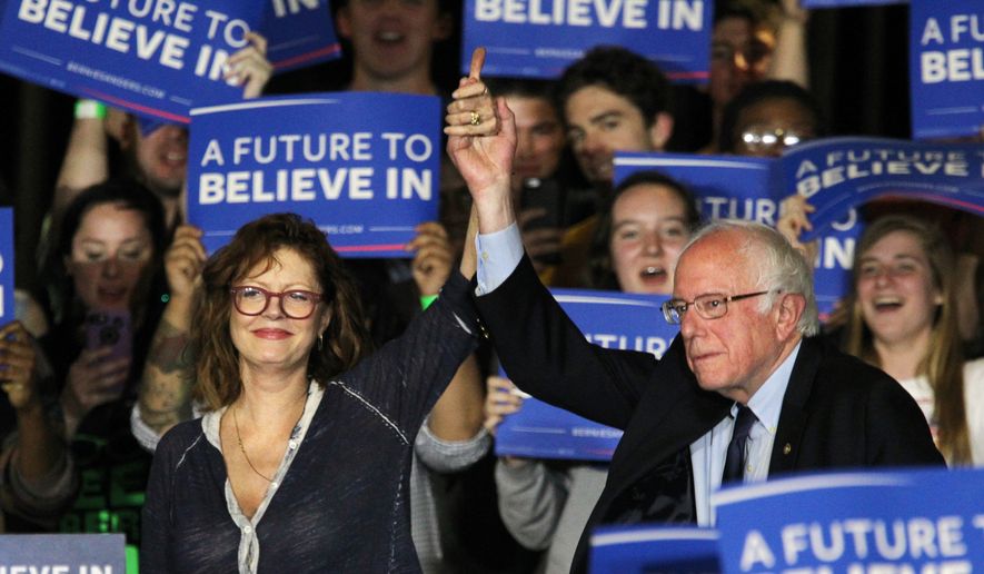 The actress Susan Sarandan, left, holds hands with Democratic presidential candidate Bernie Sanders, I-Vt., during a a rally at Drexel University in Philadelphia, Monday, April 25, 2016. (Michael Bryant/The Philadelphia Inquirer via AP)