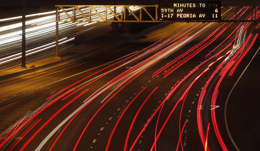 FILE - In this Sept. 21, 2015, file photo, traffic zips along the I-10 in Phoenix, as traffic signs no longer warn motorists about calling in on the I-10 freeway shooting tip line. Gov. Doug Ducey has been criticized for sending out a "We got him!" tweet just minutes after a state police SWAT team arrested Leslie Allen Merritt Jr., the 21-year-old father of two, implying that Merritt was guilty of the shootings before he had even been booked into jail or appeared in court. A judge has dismissed a criminal case against Merritt, who had been accused of carrying out freeway shootings. The ruling came Monday, April 25, after prosecutors had asked for charges against Merritt to be dismissed amid undisclosed questions about evidence. (AP Photo/Ross D. Franklin, File)