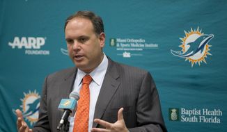 In this Jan. 4, 2016 file photo, Miami Dolphins executive vice president of football operations, Mike Tannenbaum, gestures as he speaks to members of the media at Dolphins training facility in Davie, Fla. The Miami Dolphins believe they have the answers that will solve their draft woes of recent years. They’re giving prospects the questions, using a new IQ exam that tests a prospect&#39;s reaction to specific formations and plays. (AP Photo/Wilfredo Lee, File) **FILE**