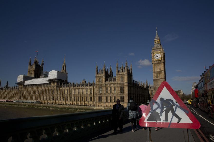 A roadworks sign stands on Westminster Bridge, near the Houses of Parliament and Elizabeth Tower, which houses the Big Ben bell in London, Tuesday, April 26, 2016. Officials say the chimes of Britain's Big Ben bell will fall silent for several months during a three-year restoration of Parliament's crumbling clock tower. (AP Photo/Matt Dunham)