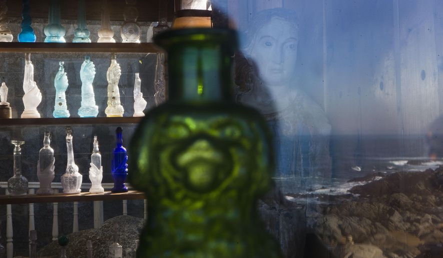 A collection of glass bottles that belonged to Chile's Nobel Prize-winning poet Pablo Neruda are displayed on the bar of his former home, now a museum, on the day he was reburied here on Isla Negra, Chile, Tuesday, April 26, 2016. Neruda's body was exhumed in 2013 for a fourth time in an effort to clear up four decades of suspicion about how the poet died in the days after Chile's military coup. The results of the analysis will be delivered on May 5. (AP Photo/Esteban Felix)