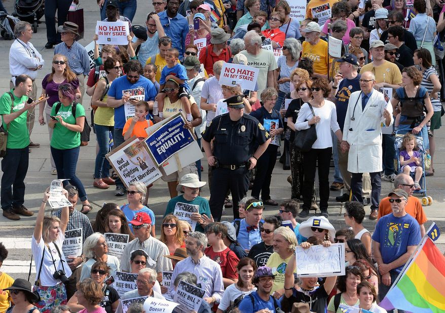 Protesters head into the Legislative building for a sit-in against House Bill 2 in Raleigh, N.C., Monday, April 25, 2016. While demonstrations circled North Carolina's statehouse on Monday, for and against a Republican-backed law curtailing protections for LGBT people and limiting public bathroom access for transgender people, House Democrats filed a repeal bill that stands little chance of passing. (Chuck Liddy/The News & Observer via AP) MANDATORY CREDIT