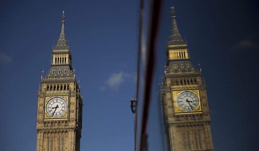 Elizabeth Tower, which houses the Big Ben bell, at the Houses of Parliament is reflected in a bus window in London, Tuesday, April 26, 2016. Officials say the chimes of Britain's Big Ben bell will fall silent for several months during a three-year restoration of Parliament's crumbling clock tower. (AP Photo/Matt Dunham)