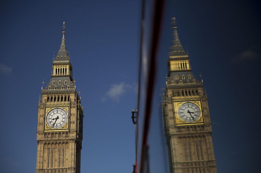 Elizabeth Tower, which houses the Big Ben bell, at the Houses of Parliament is reflected in a bus window in London, Tuesday, April 26, 2016. Officials say the chimes of Britain's Big Ben bell will fall silent for several months during a three-year restoration of Parliament's crumbling clock tower. (AP Photo/Matt Dunham)