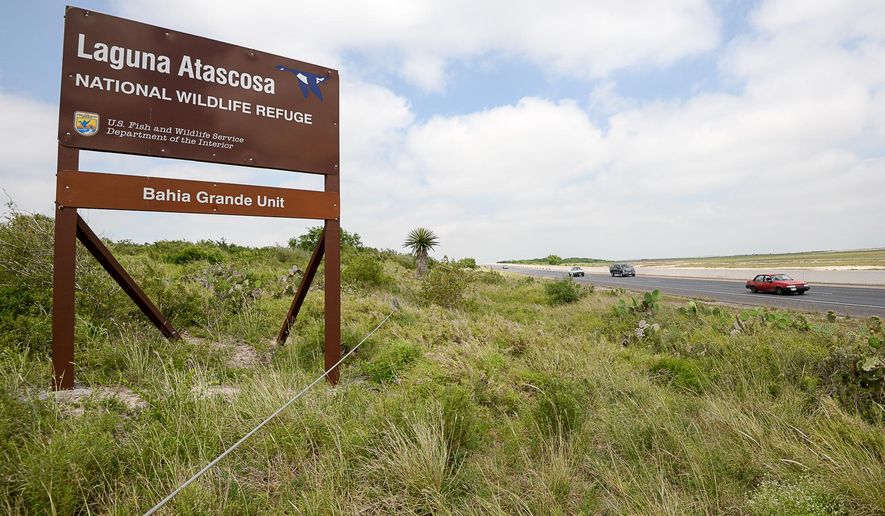 Trafic rolls along state highway 48 Monday, April 25, 2016, along the Bahia Grande near Brownsville, Texas. The Port of Brownsville and the U.S. Fish and Wildlife Service are working toward creating a wildlife corridor that would create a link between Boca Chica and the Laguna Atascosa National Wildlife Refuge, providing a safe passage for animals, especially threatened species. (Jason Hoekema/The Brownsville Herald via AP) MANDATORY CREDIT