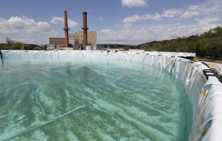 Clean water from coal ash rests in a 900,000 gallon retention tank prior to being pumped into the James River at a treatment facility outside Dominion Powers Bremo Bluff power plant in Bremo Bluff, Va., Tuesday, April 26, 2016. The sediment in the tank is from James River water that was used to test the tank prior to use. (AP Photo/Steve Helber)