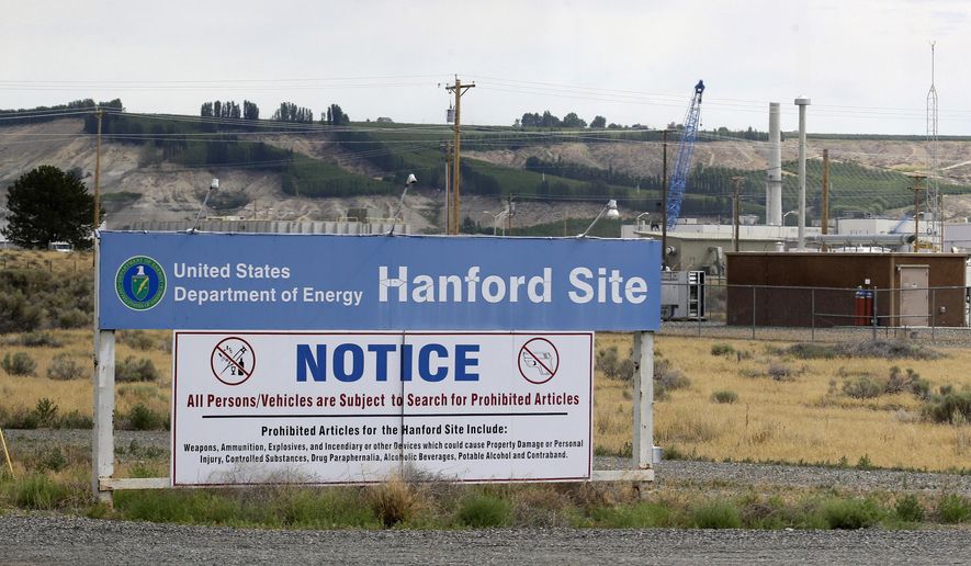 FILE - In this July 9, 2014, file photo, a sign informs visitors of prohibited items on the Hanford Nuclear Reservation near Richland, Wash. Officials for the Hanford Nuclear Reservation are trying to determine if a second giant underground tank containing radioactive waste from the production of plutonium for nuclear weapons is leaking, the U.S. Department of Energy revealed on Tuesday, April 26. (AP Photo/Ted S. Warren, File)