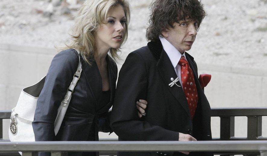 FILE - In this March 28, 2008 file photo, music producer Phil Spector and his wife Rachelle Spector, arrive at the Los Angeles County Superior Court for a discovery hearing in downtown Los Angeles. An attorney for Spector's wife Rachelle wrote in a statement issued Tuesday, April 26, 2016, that the producer's divorce filing is "heartbreakingly bizarre" and that she has been a devoted wife who has given him the best possible care while he is imprisoned for the shooting death of actress Lana Clarkson. (AP Photo/Nick Ut, File)