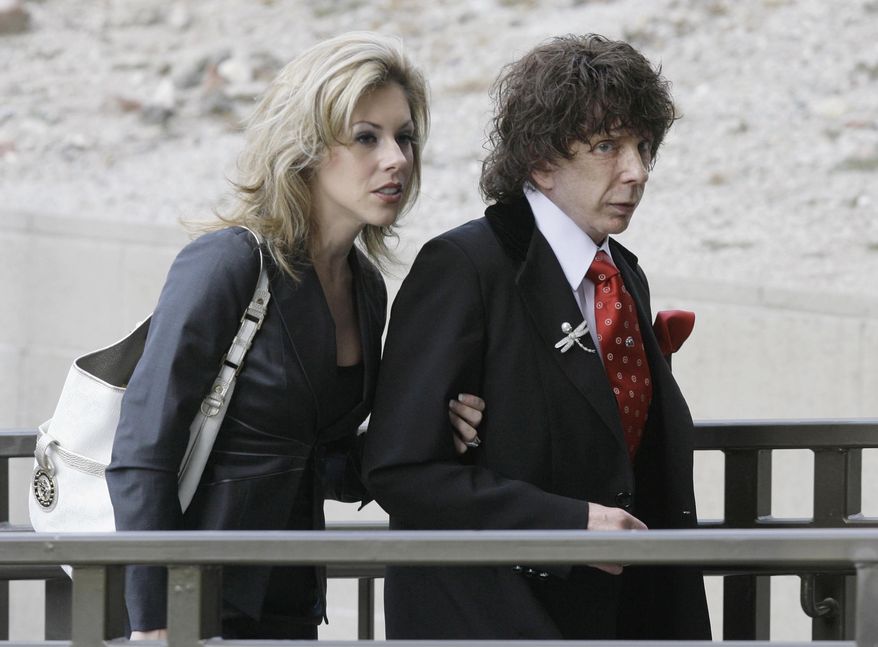 FILE - In this March 28, 2008 file photo, music producer Phil Spector and his wife Rachelle Spector, arrive at the Los Angeles County Superior Court for a discovery hearing in downtown Los Angeles. An attorney for Spector's wife Rachelle wrote in a statement issued Tuesday, April 26, 2016, that the producer's divorce filing is "heartbreakingly bizarre" and that she has been a devoted wife who has given him the best possible care while he is imprisoned for the shooting death of actress Lana Clarkson. (AP Photo/Nick Ut, File)