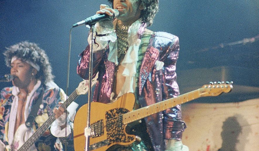 FILE - In this 1985 file photo, singer Prince performs in concert. Prince's old band is reuniting for some live shows following his death. Members of the Revolution made the announcement in a video posted online Tuesday, April 26, 2016. (AP Photo, File)