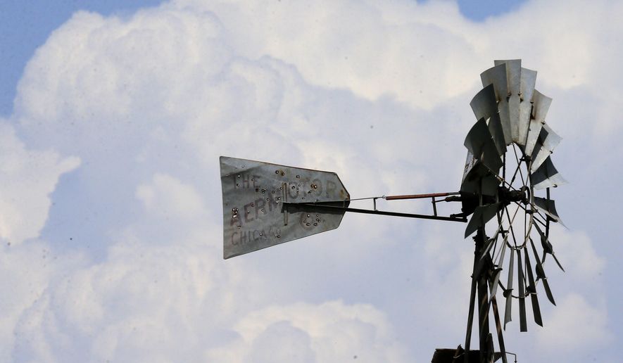 Storm clouds build up behind a windmill near Ellsworth, Kan., Tuesday, April 26, 2016. The plains are bracing for a possible severe weather outbreak. (AP Photo/Orlin Wagner)