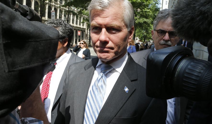 FILE -In this May 12, 2015 file photo, former Virginia Gov. Bob McDonnell navigates a group of cameras as he leaves the 4th U.S. Circuit Court of Appeals in Richmond, Va. The Supreme Court will decide how far politicians can go in doing favors for people who give them money as it takes up the public corruption case of McDonnell. (AP Photo/Steve Helber, File)