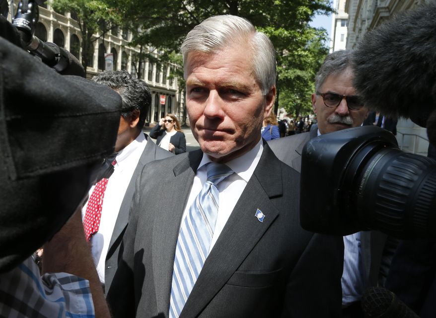 FILE -In this May 12, 2015 file photo, former Virginia Gov. Bob McDonnell navigates a group of cameras as he leaves the 4th U.S. Circuit Court of Appeals in Richmond, Va. The Supreme Court will decide how far politicians can go in doing favors for people who give them money as it takes up the public corruption case of McDonnell. (AP Photo/Steve Helber, File)