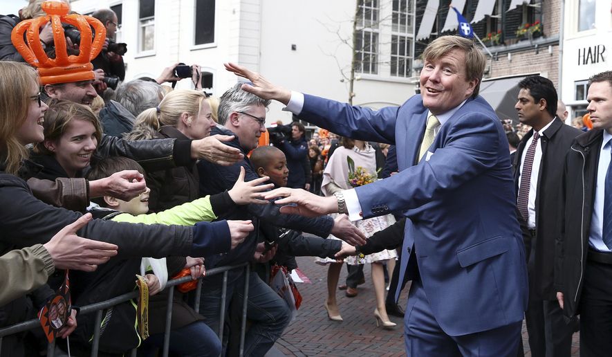 King Willem-Alexander greets well-wishers during King's Day celebrations in Zwolle, Netherlands, Wednesday April 27, 2016. The Dutch are marking their king's birthday with an official celebration in the northeastern city of Zwolle and festivals and unofficial garage sales around the nation. (Photo by Andreas Rentz, Pool)
