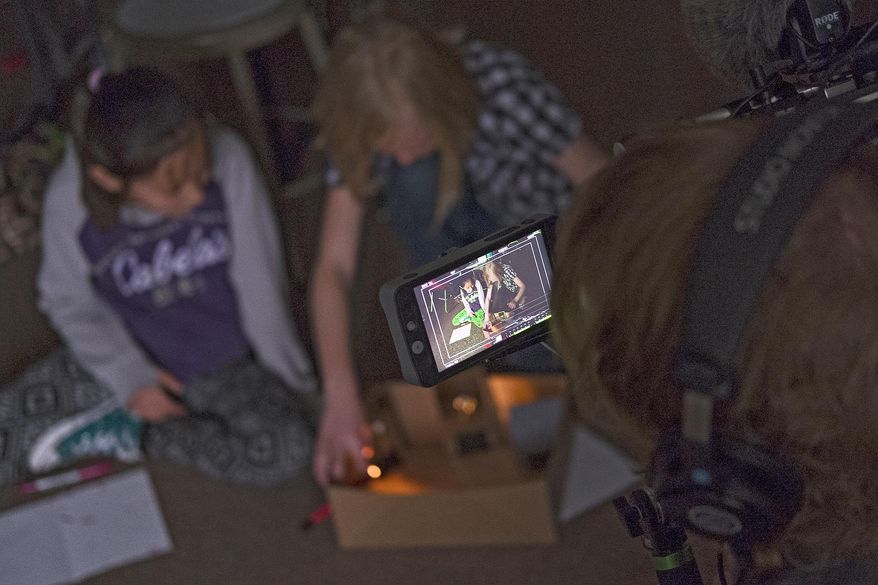 ADVANCE FOR THE WEEKEND OF APRIL 30-MAY 1 AND THEREAFTER - In a Wednesday, April 20, 2016 photo, a PBS camera operator films a pair of Jami Howe’s fourth-grade students as they work on a science exercise at Paintbrush Elementary School in Gillettte, Wyo. Campbell County's science program has garnered nationwide media attention which brought John Tulenko of "Education Week/PBS New Hour" to the school with a film crew to document a hands-on science project. (Ed Glazar/Gillette News Record via AP) TV OUT; MANDATORY CREDIT