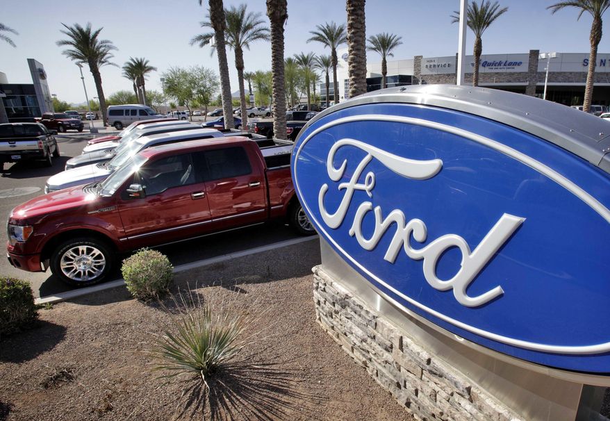 FILE - In this March 29, 2011 file photo, new 2011 Ford F-150 trucks are shown at a dealership in Glbert, Ariz. Ford is recalling nearly 202,000 pickup trucks, SUVs and cars in North America because the automatic transmissions can suddenly downshift to first gear.The company also said Wednesday, April 27, 2016, that it’s recalling more than 81,000 Explorer SUVs to fix a rear suspension problem.The transmission recall covers the 2011 and 2012 F-150 and the 2012 Expedition, Mustang and Lincoln Navigator. (AP Photo/Matt York)