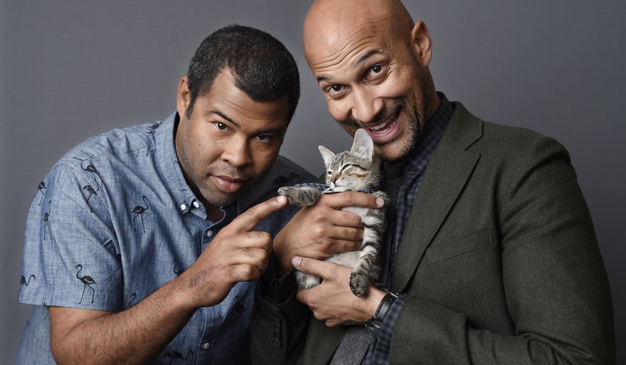 In this April 23, 2016 photo, Jordan Peele, left, and Keegan-Michael Kay hold a ten-week-old tabby as they pose for a portrait to promote their film, "Keanu," at The Beverly Hilton Hotel in Beverly Hills, Calif. (Photo by Chris Pizzello/Invision/AP)