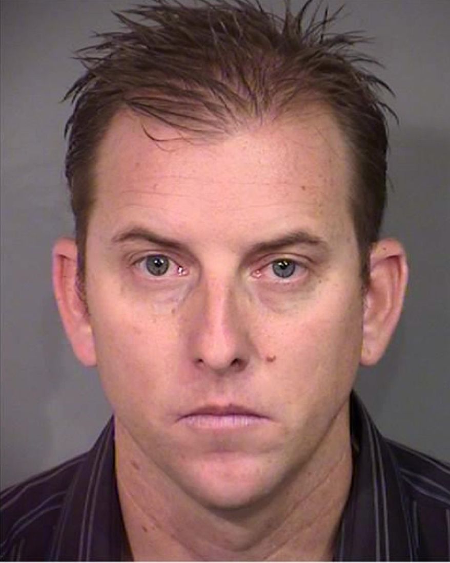 This undated photo provided Wednesday, April 27, 2016, by the Nevada state attorney general's office shows Las Vegas Police K-9 Officer Jeff Lynn Harper. Harper is facing multiple felony charges alleging that he burned his recreational vehicle trailer in January for the insurance money. A police spokeswoman says Harper will be suspended without pay pending the outcome of his case.(Nevada Attorney General via AP)