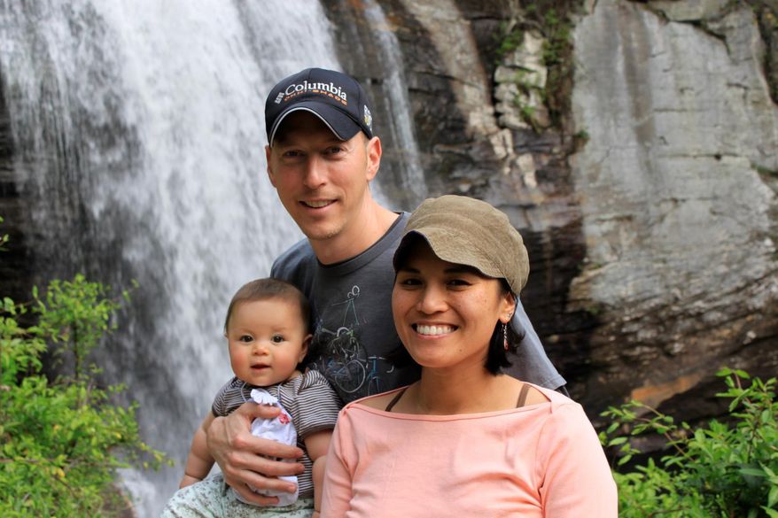 In this 2012 photo provided by Jamie Gilpin, Gilpin, center, poses for a photo with his wife, Joy Cadelina Gilpin, right, and daughter, Celeste Gilpin, at Looking Glass Falls, Pisgah National Forest, near Asheville, N.C. Small businesses in North Carolina are worried about fallout from the new state law limiting protections for gay, lesbian, bisexual and transgender people. Jamie Gilpin said that his bicycle tours business has seen a decline in inquiries since the law was passed. (Jim Gilpin/Courtesy of Jamie Gilpin via AP) MANDATORY CREDIT