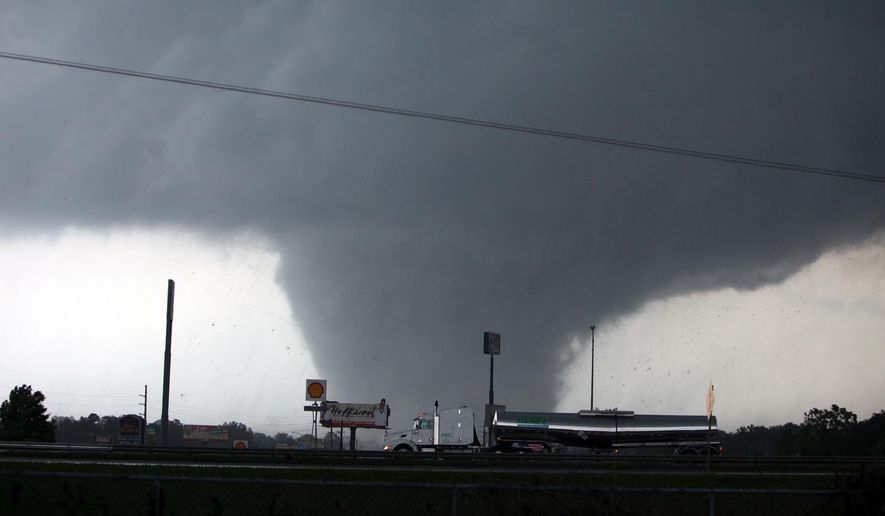 FILE - In this April 27, 2011, file photo a deadly tornado moves through Tuscaloosa, Ala. On April 27, 2011, a series of tornadoes killed hundreds of people, injured thousands and reduced countless buildings to rubble across a swath of the U.S. More than 120 tornadoes were reported that day - one of the deadliest outbreaks in the nation's history. (Dusty Compton/The Tuscaloosa News, via AP, File) MANDATORY CREDIT