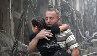 A man carries a child after airstrikes hit Aleppo, Syria, on Thursday. A Syrian monitoring group and a first-responders team say new airstrikes on the rebel-held part of the contested city of Aleppo have killed over a dozen people and brought down at least one residential building. (Associated Press)