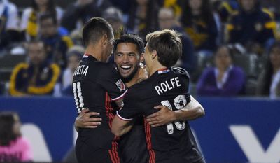 D.C. United midfielder Lamar Neagle, center, celebrates his goal with midfielder Luciano Acosta, left, and forward Chris Rolfe during the first half of an Major League Soccer match against the Los Angeles Galaxy, Sunday, March 6, 2016, in Carson, Calif. (AP Photo/Mark J. Terrill) **FILE**