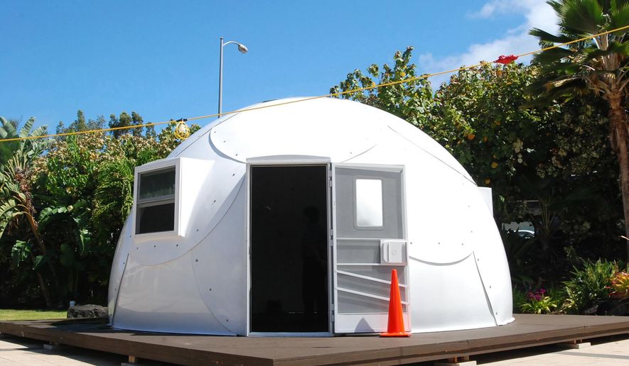 In this Friday, April 22, 2016 photo, a dome-shaped shelter is shown at the First Assembly of God church in Honolulu. The church is looking into an unexpected solution to state's homeless crisis: they're planning to erect Alaska-made igloos to house homeless families. The snow-inspired dome-shape structures would appear at first glance to be a misfit among the island state's palm trees and sandy beaches, but their bright fiberglass exterior reflects the sun, shading those inside. (AP Photo/Caleb Jones)