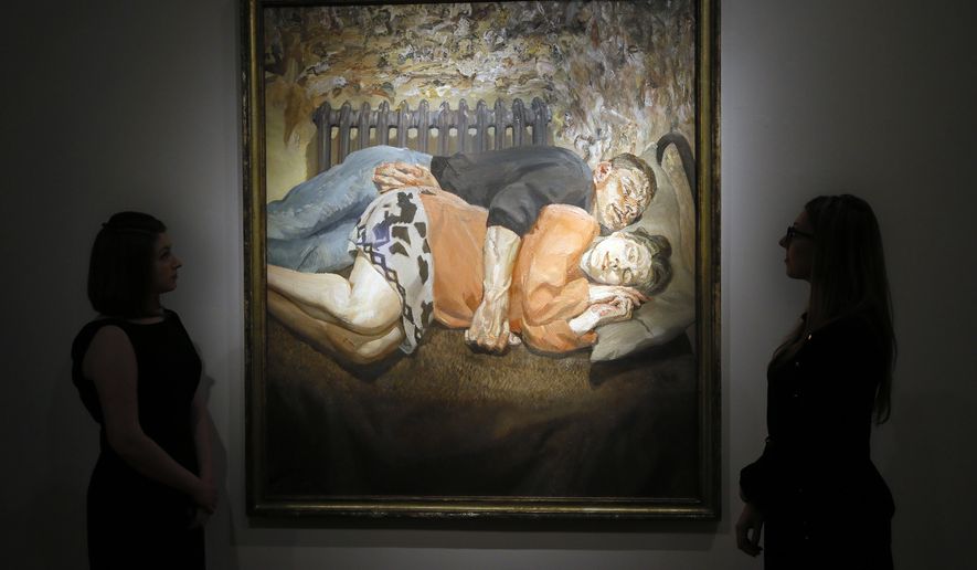 Christie's employees look towards a family portrait from 1992 by Lucian Freud, at their auction rooms in London, Thursday, April 28, 2016. The painting valued at 18 million UK pounds (26.25 million US dollars) will be auctioned on June 30 in the Defining British Art sale. (AP Photo/Kirsty Wigglesworth)