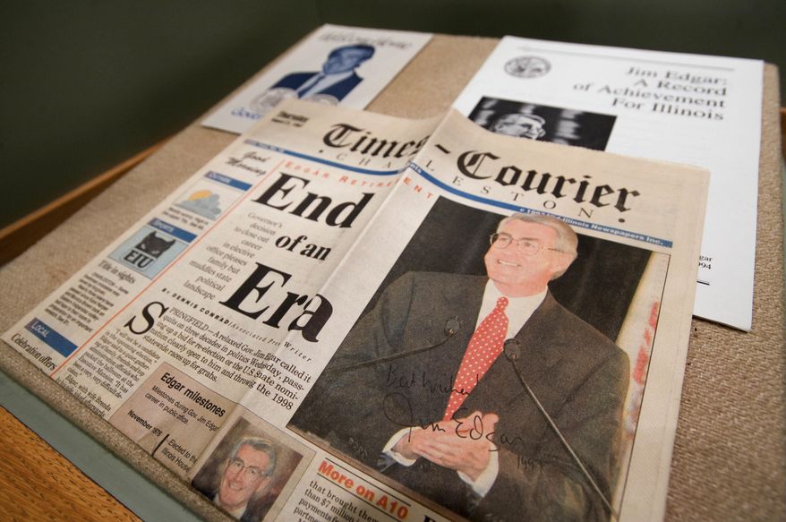 ADVANCE FOR USE SUNDAY, MAY 1 AND THEREAFTER - In this April 7, 2016 photo, a signed copy of the Charleston Times-Courier newspaper with a story on Jim Edgar's time as Illinois governor is displayed at the new exhibit, "A Campaign History in Coles County," that shows how campaigns and elections have changed over the years. The exhibit features local, state and national election and campaign materials. (Kevin Kilhoffer/Journal Gazette via AP) MANDATORY CREDIT
