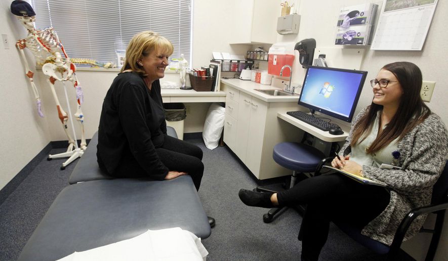 ADVANCE FOR USE SUNDAY, MAY 1 AND THEREAFTER - In this April 4, 2016 photo, Paula Reeder, left, shares a laugh with Millie Silver, an interventionist with the nurse care management program provided through Quincy Medical Group, while at a doctors appointment in Quincy, Ill. (Steve Bohnstedt)/The Quincy Herald-Whig via AP) MANDATORY CREDIT
