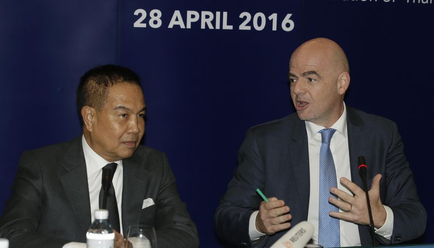 FIFA President Gianni Infantino, right, talks to President Football Association of Thailand Somyot Poompanmoung during a press conference in Bangkok, Thailand, Thursday, April 28, 2016. Infantino takes part in the celebrations of the 100th anniversary of the Football Association of Thailand. (AP Photo/Sakchai Lalit)