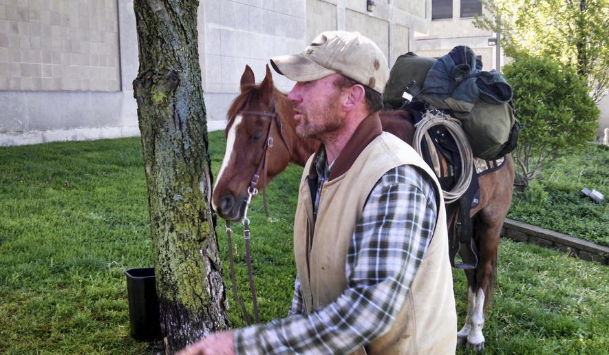 In this Thursday, April 28, 2016 photo, Ronald Blalock II is seen after arriving in Decatur, Ill., on horseback from Leroy, Ill., to attend a hearing at the Macon County Courts Facility. Blalock came up with the old-fashioned way to make sure he was there Thursday for his latest one after missing a series of previously scheduled court appearances. (Chris Lusvardi/Herald & Review via AP) MANDATORY CREDIT