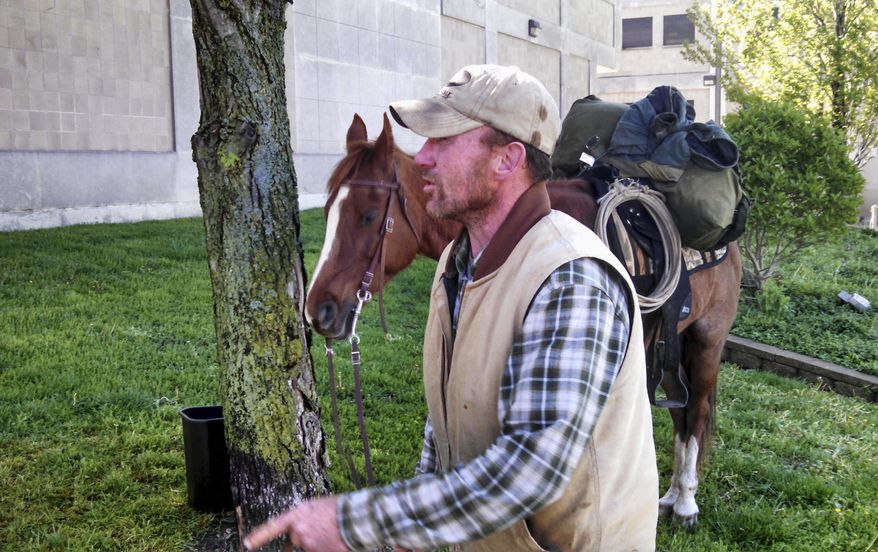 In this Thursday, April 28, 2016 photo, Ronald Blalock II is seen after arriving in Decatur, Ill., on horseback from Leroy, Ill., to attend a hearing at the Macon County Courts Facility. Blalock came up with the old-fashioned way to make sure he was there Thursday for his latest one after missing a series of previously scheduled court appearances. (Chris Lusvardi/Herald & Review via AP) MANDATORY CREDIT