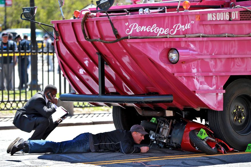 Investigators work the scene of an accident involving a Duck Boat on Saturday, April 30, 2016 in Boston. A woman has died after the scooter she was driving was struck by an amphibious sightseeing vehicle in downtown Boston. A city police department spokeswoman said the woman and her male passenger were taken to Massachusetts General Hospital, where the woman died from her injuries. The passenger suffered non-life threatening injuries. (Jonathan Wiggs /The Boston Globe via AP) BOSTON HERALD OUT, QUINCY OUT; NO SALES; MANDATORY CREDIT JONATHAN WIGGS