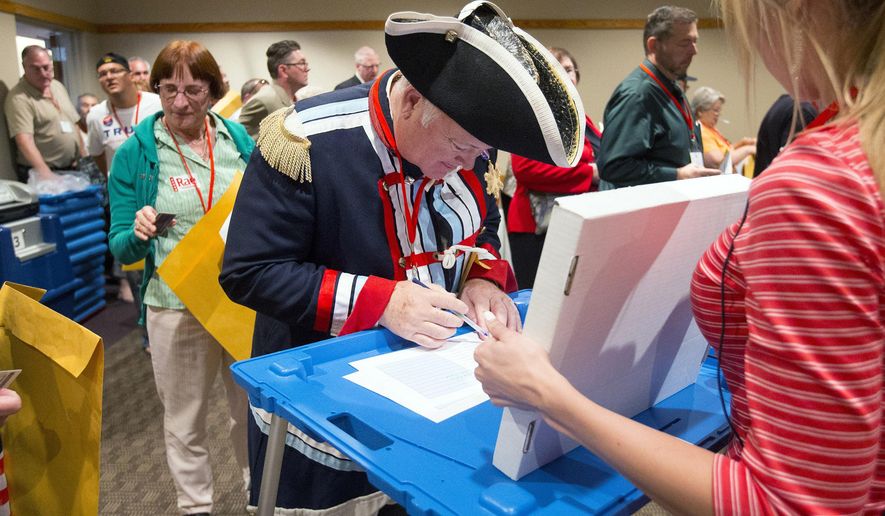 John Rosado, of Phoenix, signs in to select delegates to attend the National Republican convention during the Arizona Republican 2016 state convention at the Mesa Convention Center Saturday, April 30, 2016. (Cheryl Evans/The Arizona Republic via AP)
