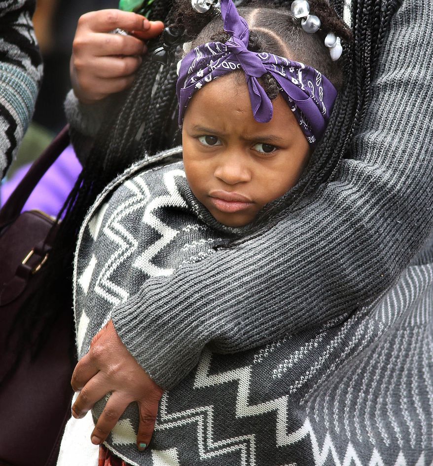 Aniyah Roland, 6, listens to Prince music in the protective arms of her aunt, Angel Jones during a Prince Block Party Saturday, April 30, 2016, at Sabathani Community Center in Minneapolis, Minn. (Jim Gehrz/Star Tribune via AP)