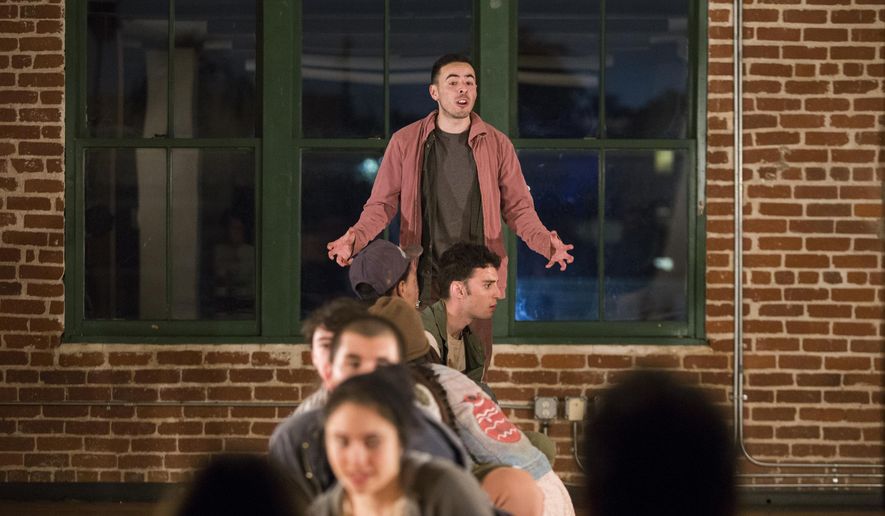 In this Friday, March 18, 2016 photo, Julian Sandoval, top, plays the part of Poncho in the play "Shelter" at CalArts Center for New Performance in Los Angeles. For Sandoval, the play "Shelter" is more than just a story of children flooding into the U.S. by the tens of thousands from Latin America in search of safe sanctuary. It's personal. The young actor's mother immigrated to the U.S. illegally years ago, fleeing the violence of her native El Salvador after seeing a cousin hacked to death by soldiers with machetes during the country's civil war. She would become a legal resident under the Immigration Reform and Control Act of 1986 and eventually a U.S. citizen. (AP Photo/ Jenna Schoenefeld)