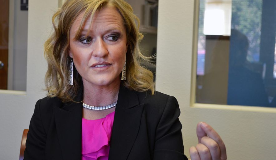In this April 21, 2016, photo, Children, Youth and Families Department Secretary Monique Jacobson talks at The Associated Press's bureau in Albuquerque about her agency's new campaign to battle child abuse. Featuring slick commercials starring Albuquerque-born UFC fighter Carlos Condit and images of children from New Mexico's Hispanic neighborhoods and American Indian Reservations, the "Pull Together" campaign seeks to engage parents and create a movement to transform the way residents sees child abuse in the state. (AP Photo/Russell Contreras)