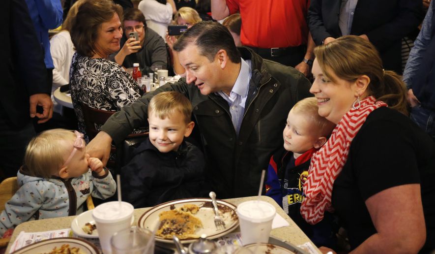 Republican presidential candidate, Sen. Ted Cruz, R-Texas, talks with Elizabeth Craig's children during a visits to the Bravo Cafe during a campaign stop, Monday, May 2, 2016, in Osceola, Ind. (AP Photo/Charles Rex Arbogast)