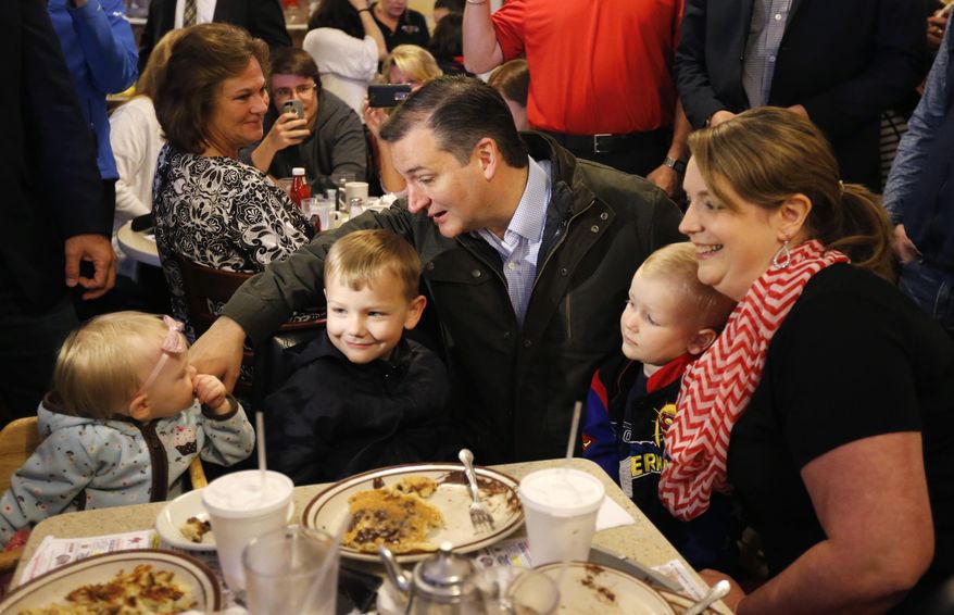 Republican presidential candidate, Sen. Ted Cruz, R-Texas, talks with Elizabeth Craig's children during a visits to the Bravo Cafe during a campaign stop, Monday, May 2, 2016, in Osceola, Ind. (AP Photo/Charles Rex Arbogast)
