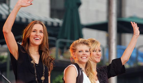 In this May 26, 2006, file photo, Dixie Chicks, from left, Emily Robison, Natalie Maines and Martie Maguire, wave to the crowd as they perform on ABC&#39;s &amp;quot;Good Morning America&amp;quot; summer concert series in Bryant Park, in New York. The Dixie Chicks are adding more concerts to their U.S. tour that starts this summer 2016. (AP Photo/Dima Gavrysh, File)