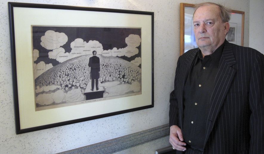 In this Friday, April 29, 2016 photo, attorney Bruce Rubenstein, a collector of left-wing political memorabilia, stands in front of a 1920s drawing by political cartoonist Art Young on April 29, 2016 inside his office in Hartford, Conn. Rubenstein is threatening to sue the University of Hartford which plans to sell a political memorabilia collection to which Rubenstein donated hundreds of items. (AP Photo/Pat Eaton-Robb)