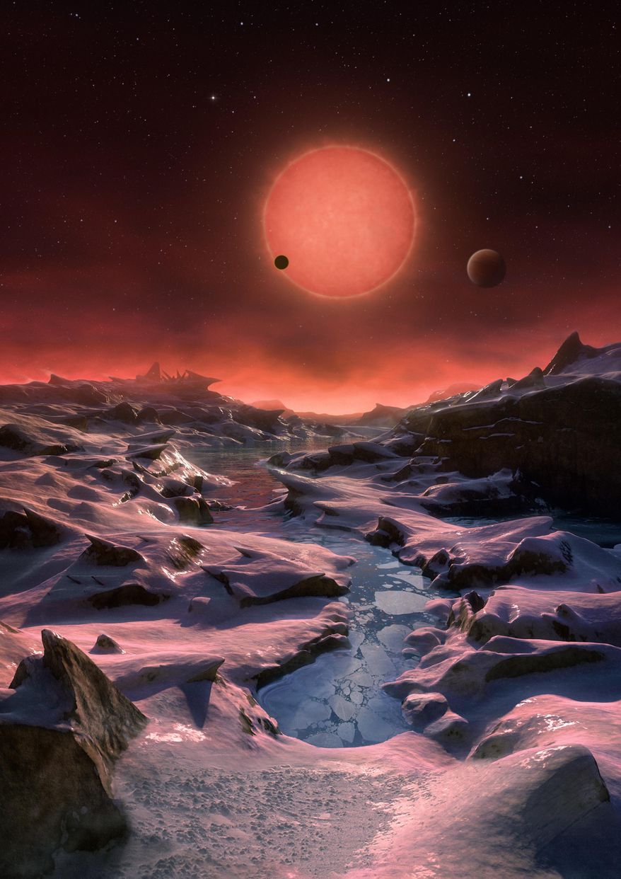 The artist's impression provided by European Southern Observatory on May 2, 2016 shows an imagined view from the surface one of the three planets orbiting an ultracool dwarf star just 40 light-years from earth that were discovered using the TRAPPIST telescope at ESO's La Silla Observatory. (ESO/M. Kornmesser via AP) MANDATORY CREDIT