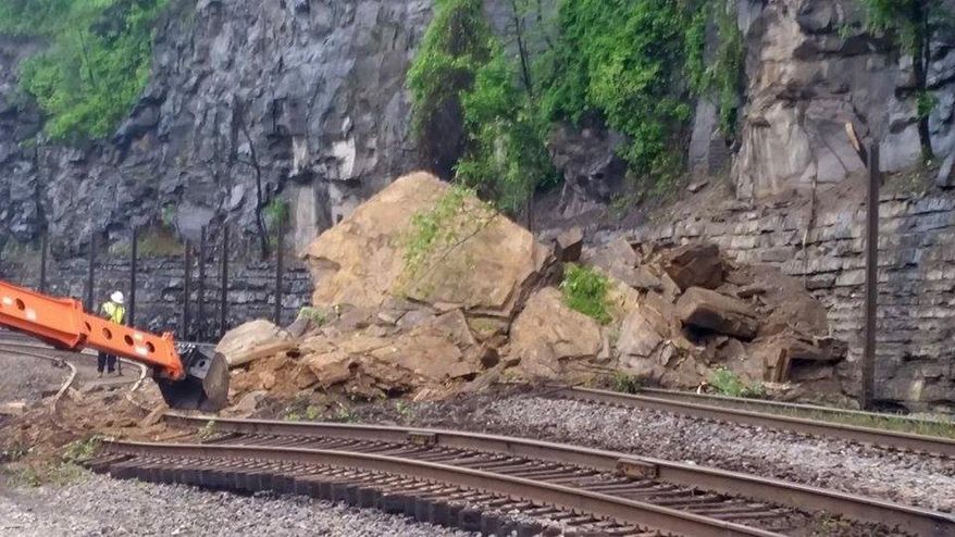 A rock slide damaged both the north and south bound railroad tracks of Norfolk Southern near the Chattaroy crossing just north of Williamson, W.V., early Monday, May 2, 2016. Heavy rainfall this past weekend apparently caused the rock slide. (Kim Chapman/Williamson Daily News via AP)