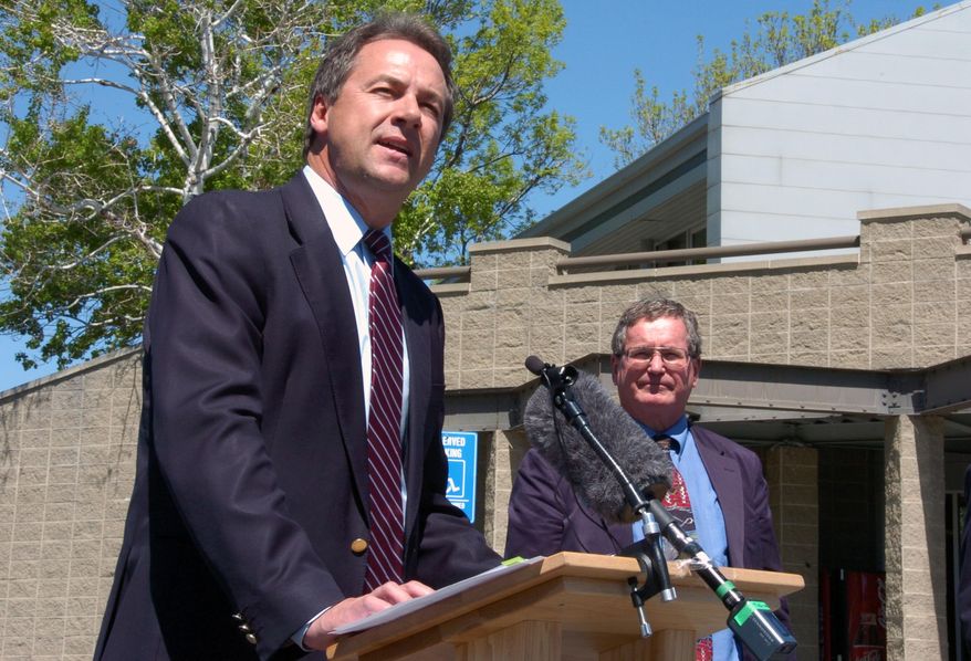 Montana Gov. Steve Bullock talks about reductions in sulfur dioxide pollution during a May 3, 2016 press conference in Billings, Mont. as state Department of Environmental Quality Director Tom Livers looks on. The U.S. Environmental Protection Agency is reversing a 2013 finding that Billings was out of compliance with air pollution standards, after the closure of a coal-burning power plant eased the problem. (AP Photo/Matthew Brown)